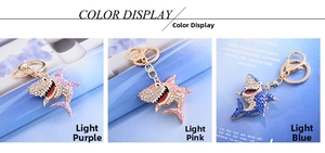 Sparkling crystal shark keychains in light purple, pink, and blue with gold lobster clasps