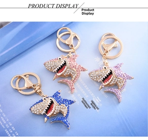 Detail view of pink purple and blue shark keychains with sparkling rhinestones