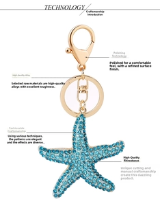 Polished gold alloy keychain featuring a sea star pendant with blue rhinestones