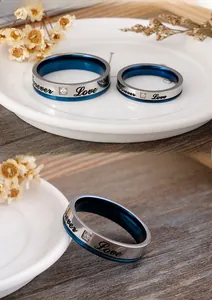 Detail of silver and blue Forever Love engraved couple rings with cubic zirconia