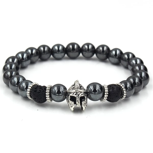 Macro detail of Spartan helmet charm and hematite beads on a men's beaded bracelet