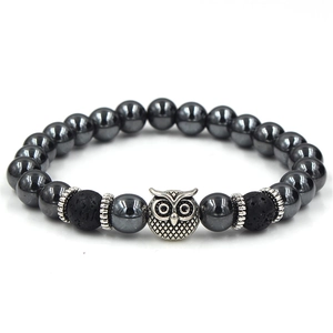 Detailed shot of hematite and lava stone beads featuring a silver owl charm and spacers