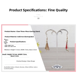 Detailed view of the three claw-shaped metal earring display stands in various heights