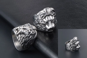 Macro detail of silver vintage lion head ring showing intricate steel carving craftsmanship