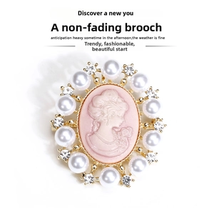 Macro detail of Victorian vintage cameo brooch with pink relief and white pearls