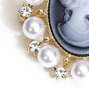 Macro detail of Victorian cameo brooch featuring pearls, crystals, and gold metalwork