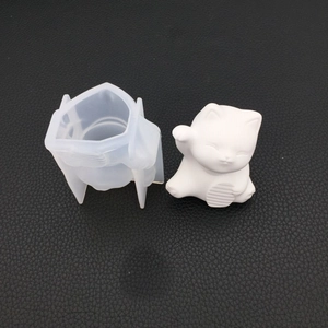 Detail of translucent silicone lucky cat mold and white gypsum cat ornament piece