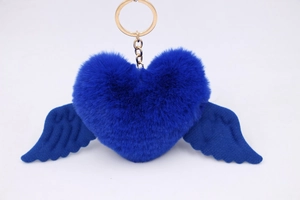 Close-up of royal blue plush heart keychain with soft wings and gold metal ring