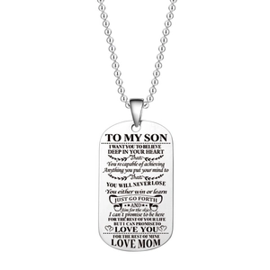 Detail of silver titanium steel dog tag necklace with engraved message to my son