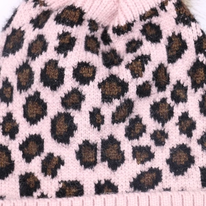 Pink leopard knit beanie with faux fur pom and thick ribbed cuff for winter warmth