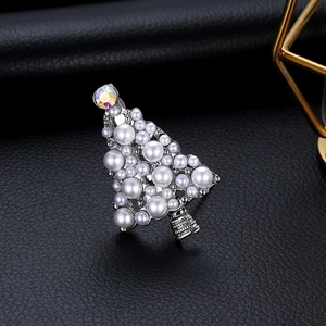 Elegant Christmas tree brooch with white pearls and colorful gemstone on black leather