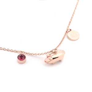 Detail of rose gold pig charm necklace with red crystal and lucky Chinese Fu pendant