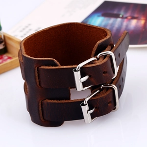 Detailed macro view of dark brown genuine leather bracelet with silver metal buckles