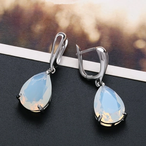Elegant rose gold drop earrings featuring pear-shaped opal stones in a luxury setting