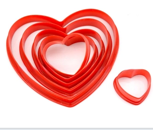 Nested set of red heart-shaped plastic cookie cutters in multiple baking sizes