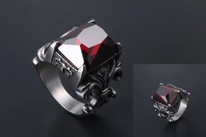 Detailed macro view of vintage titanium steel ring with red stone and floral carving