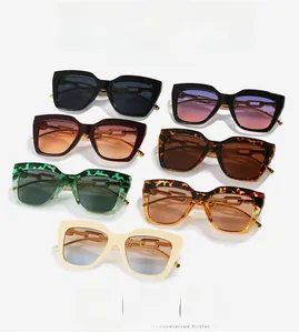 Detail of square oversized sunglasses with gold metal chain temple accents and multiple colors