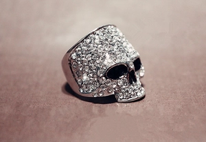 Macro detail of punk skull ring with silver finish and sparkling crystal pavé stones