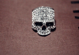 Detailed view of silver skull ring with full rhinestone inlay in hip hop punk style