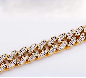 Detailed close-up of gold Cuban link chain with pave setting white zircons for hip-hop style