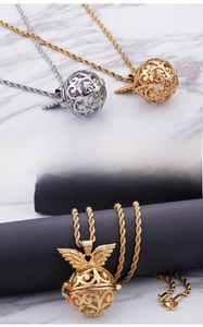 Detail of hollow sphere pendant with wings in fine steel and twisted chain texture