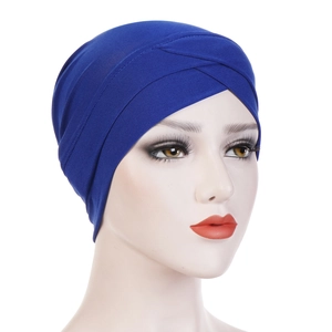 Close-up of royal blue turban hat featuring a criss-cross front design and pleated fabric