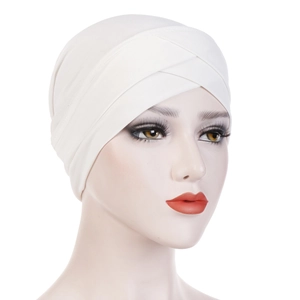 Detail of white elastic turban with cross-front design on a female mannequin head