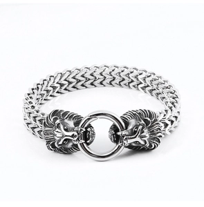 Detail of stainless steel lion head bracelet with woven chain and round buckle clasp