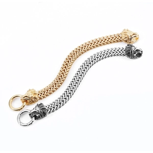 Detailed view of lion head clasps on gold and silver stainless steel braided bracelets