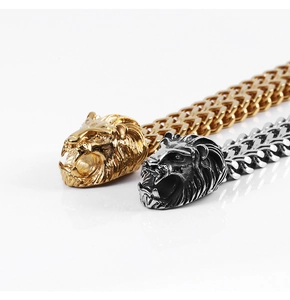 Detailed look at gold and silver lion head charms on stainless steel link bracelets