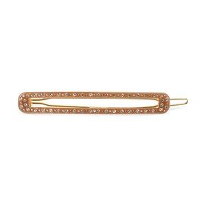 Detail of a brown acetate hair clip with golden metal base and sparkling small rhinestones