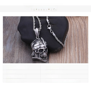 Detailed view of heavy titanium steel skull pendant with textured braided chain necklace