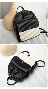 Detail view of monochrome PU leather backpack with tassel zippers and gold snap button
