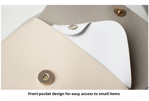 Detail of front pocket with gold magnetic clasp on a beige faux leather backpack