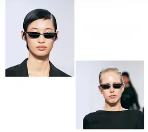 Detail of narrow rectangular black sunglasses with silver frames and cat-eye design