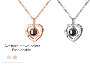 Detail of heart necklaces in rose gold and silver with center projection gemstone