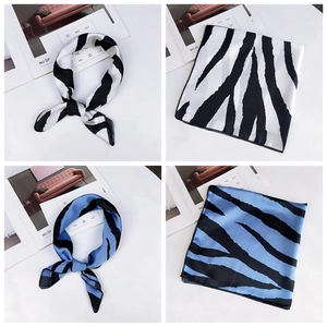 Detail of zebra pattern silk scarf featuring black and white textures with glossy finish