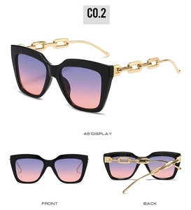Macro detail of oversized square sunglasses featuring chic golden chain temples and gradient lenses