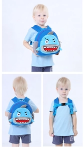 Detail of child shark backpack with wide padded straps and safety chest buckle clip
