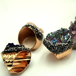 Macro shot of adjustable gold rings with raw crystal druzy and micro-set accents