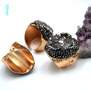 Detailed view of silver agate druzy crystal rings with sparkling raw gemstone clusters