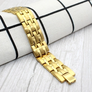 15mm gold stainless steel magnetic bracelet displayed on a wood and grid background