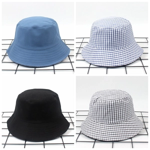 Detail view of cotton bucket hats in solid and checkered patterns on a grid display