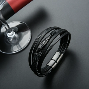 Men's multilayer black braided leather bracelet with a dark steel feather pendant