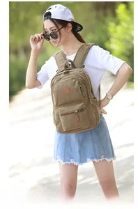 Close-up of a khaki canvas backpack with leather details for outdoor leisure travel