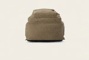 Close-up of the durable reinforced black bottom and khaki canvas texture of the backpack