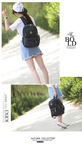 Detail of a minimalist black canvas backpack used for travel and casual outdoor activities