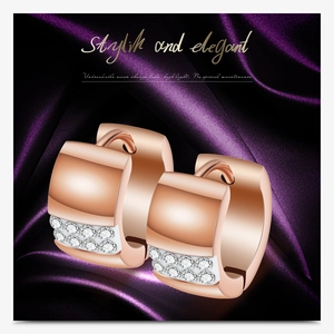 Macro detail of rose gold hoop earrings with double row cubic zirconia on purple silk