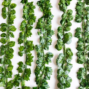 Vertical view of five realistic artificial ivy and succulent vines with varied green leaves