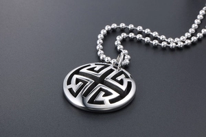 Detailed macro shot of vintage hollow double circle silver pendant on a bead chain